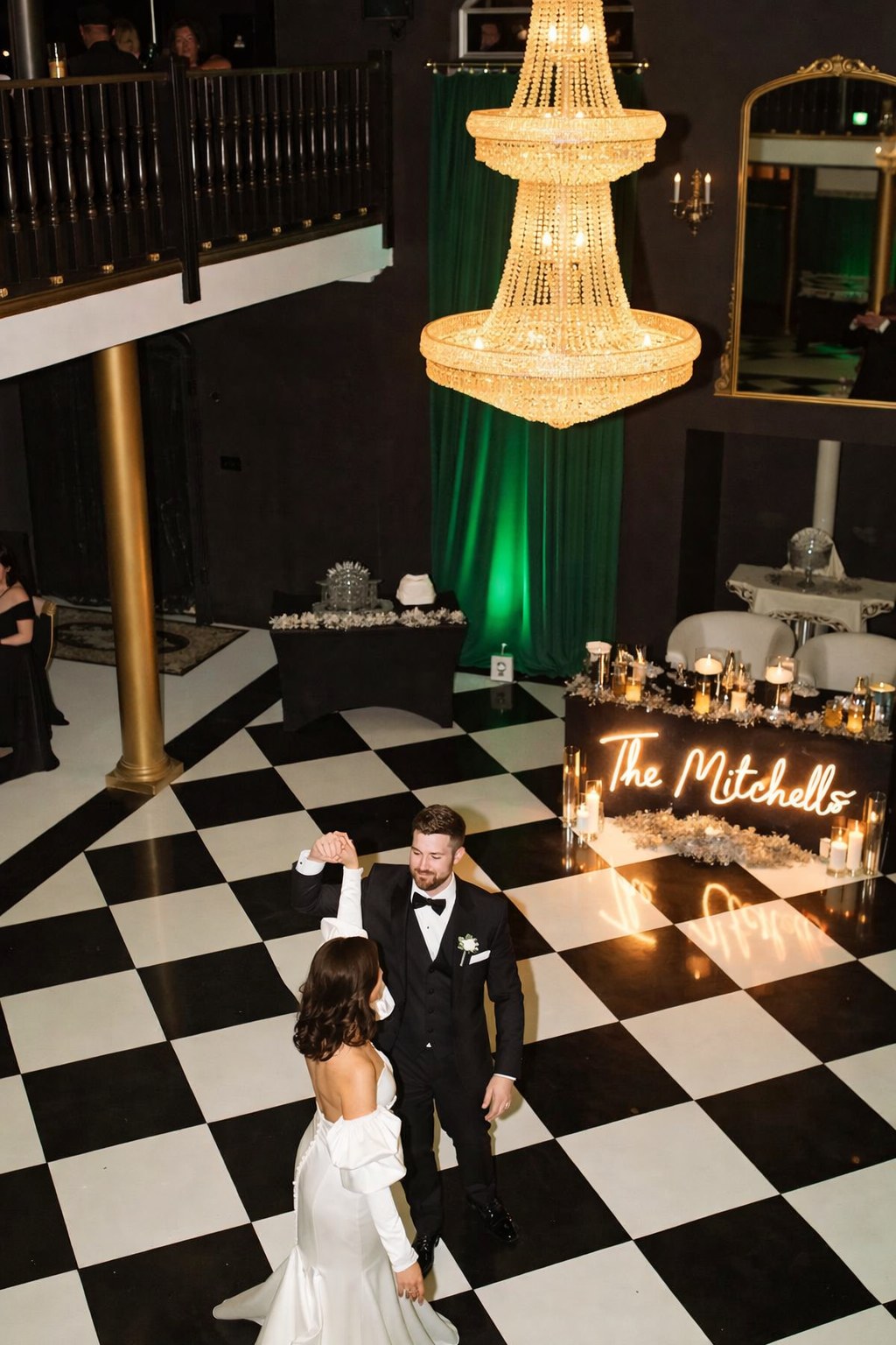 Chandelier lit ballroom with a checkerboard dance floor set up for a Denver wedding