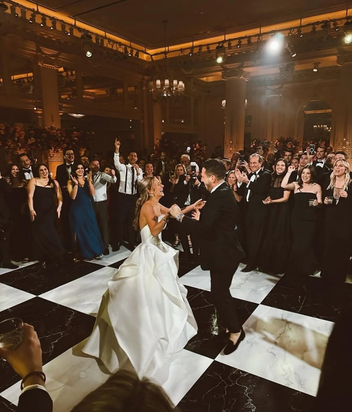 Checkerboard dance floor set up under a tent at an outdoor Denver wedding reception